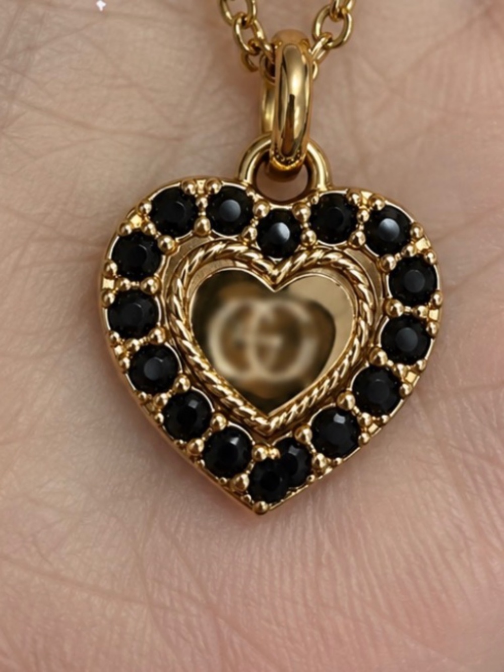 Luxury stamped black beaded heart charm necklace on a chain